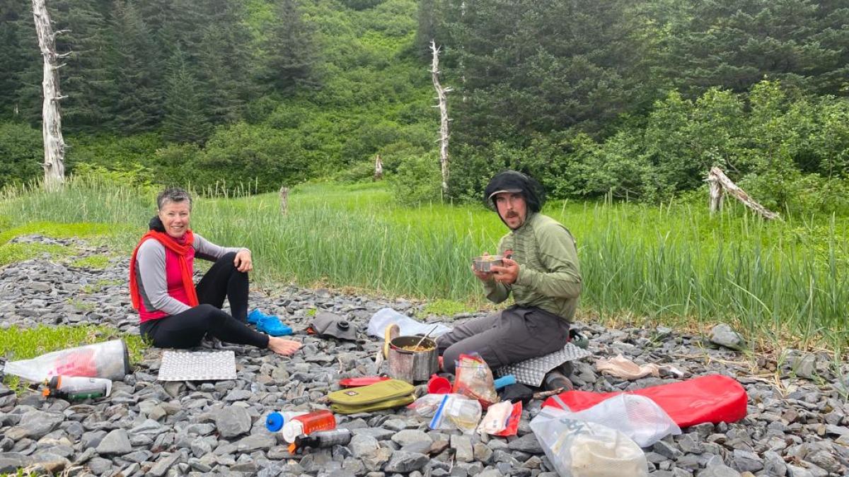 a group of people sitting on a rock