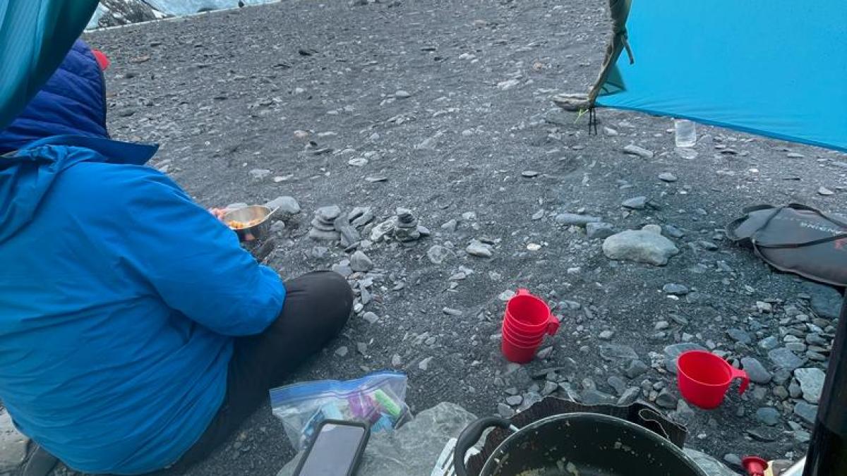 a group of people sitting at a beach