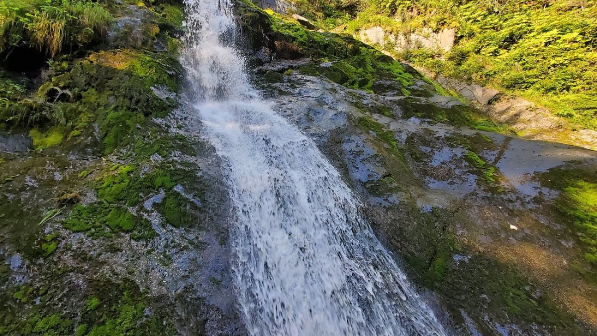 a large waterfall over some water