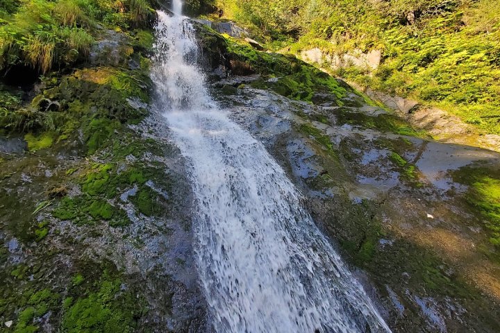 a large waterfall over some water