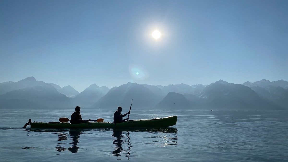 a group of people in a boat on a body of water