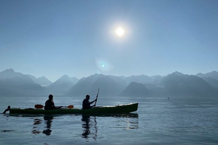 a group of people in a boat on a body of water
