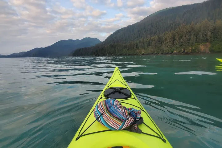 a green boat on a body of water