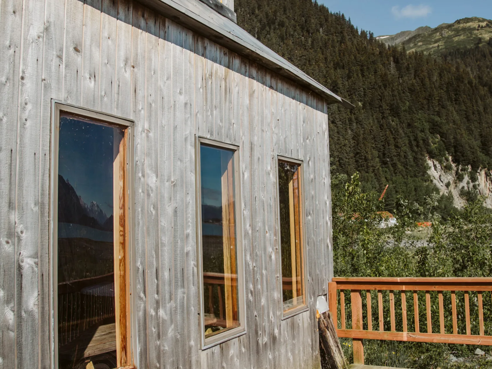 a wooden bench on the side of a building