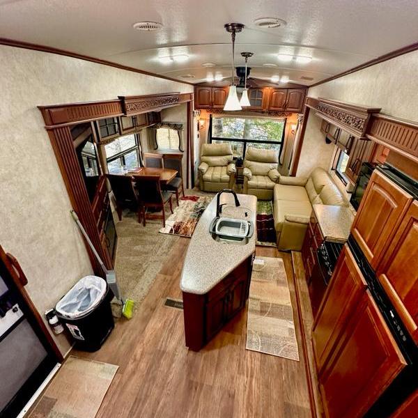 the living room filled with furniture of a 5th wheel camper