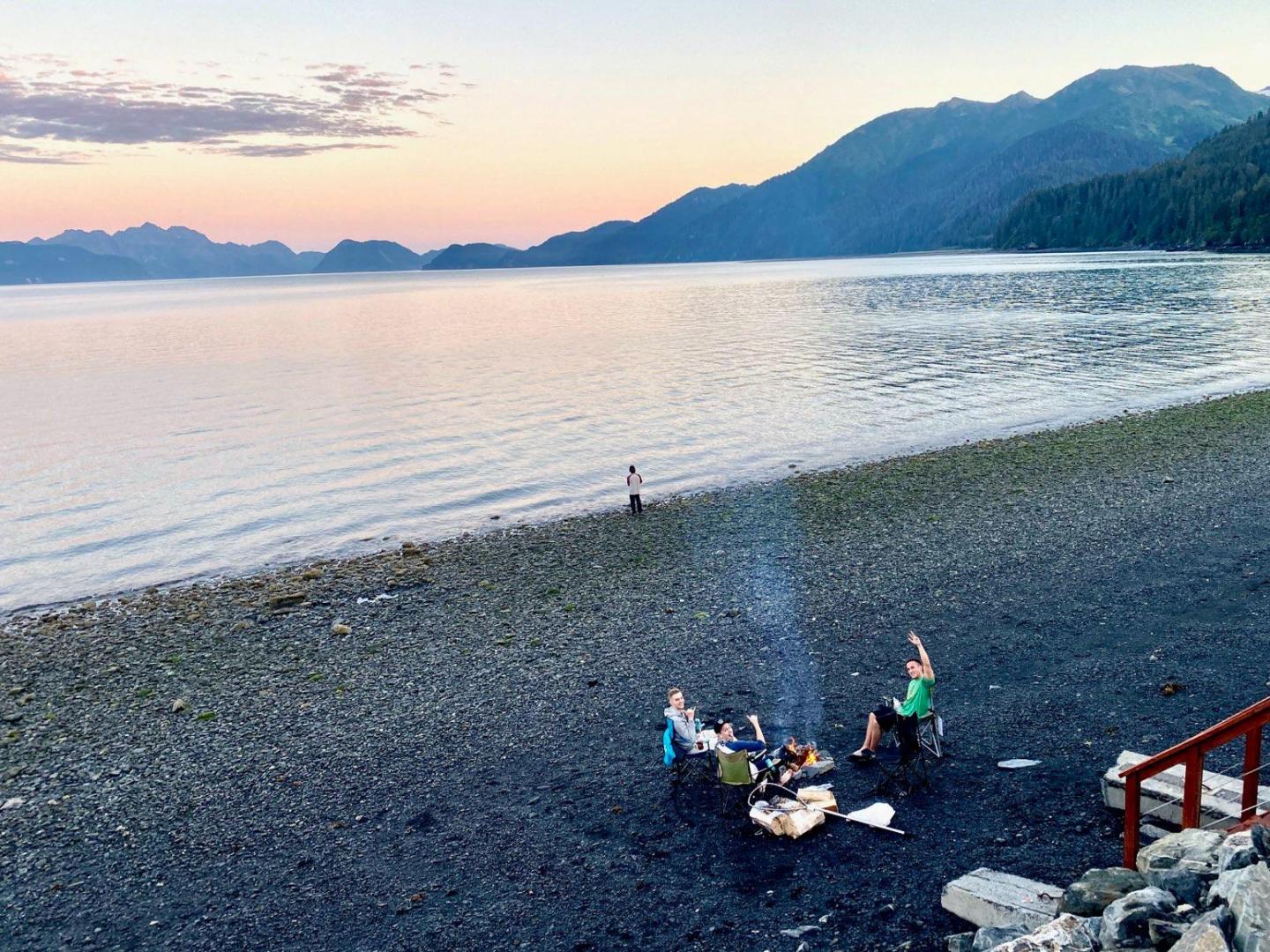 a group of people on a beach near a body of water