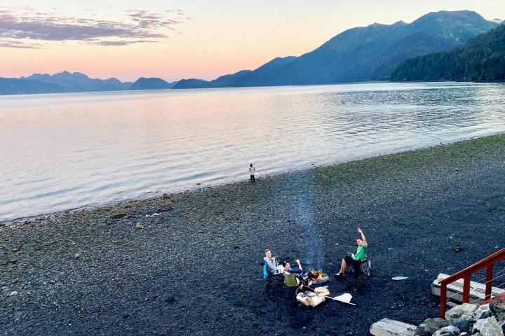 a group of people on a beach near a body of water
