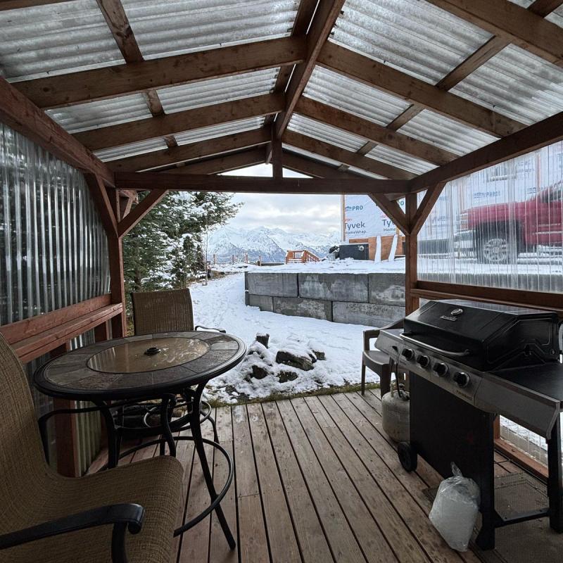 a chair sitting in front of a building with a metal fence