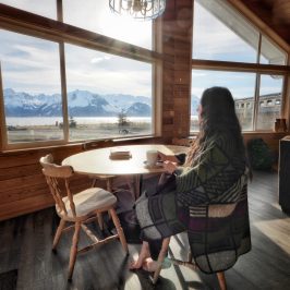a woman standing in front of a windowSeaside Beach Seward Alaska Kayaking Fishing Lodging Camping Guided Trips
