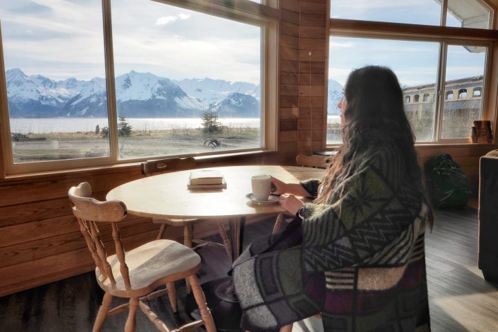 a woman standing in front of a windowSeaside Beach Seward Alaska Kayaking Fishing Lodging Camping Guided Trips