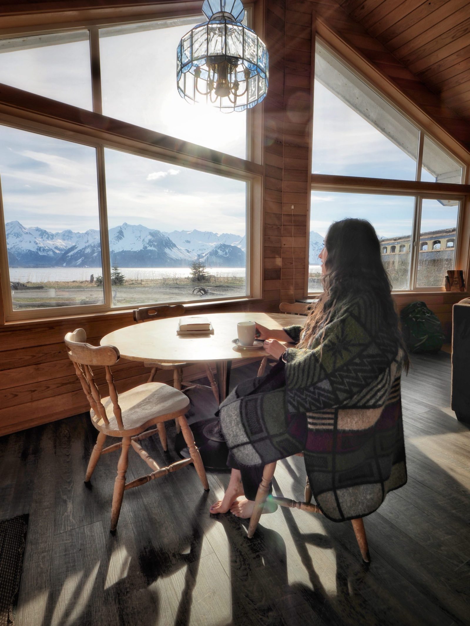 a woman standing in front of a windowSeaside Beach Seward Alaska Kayaking Fishing Lodging Camping Guided Trips
