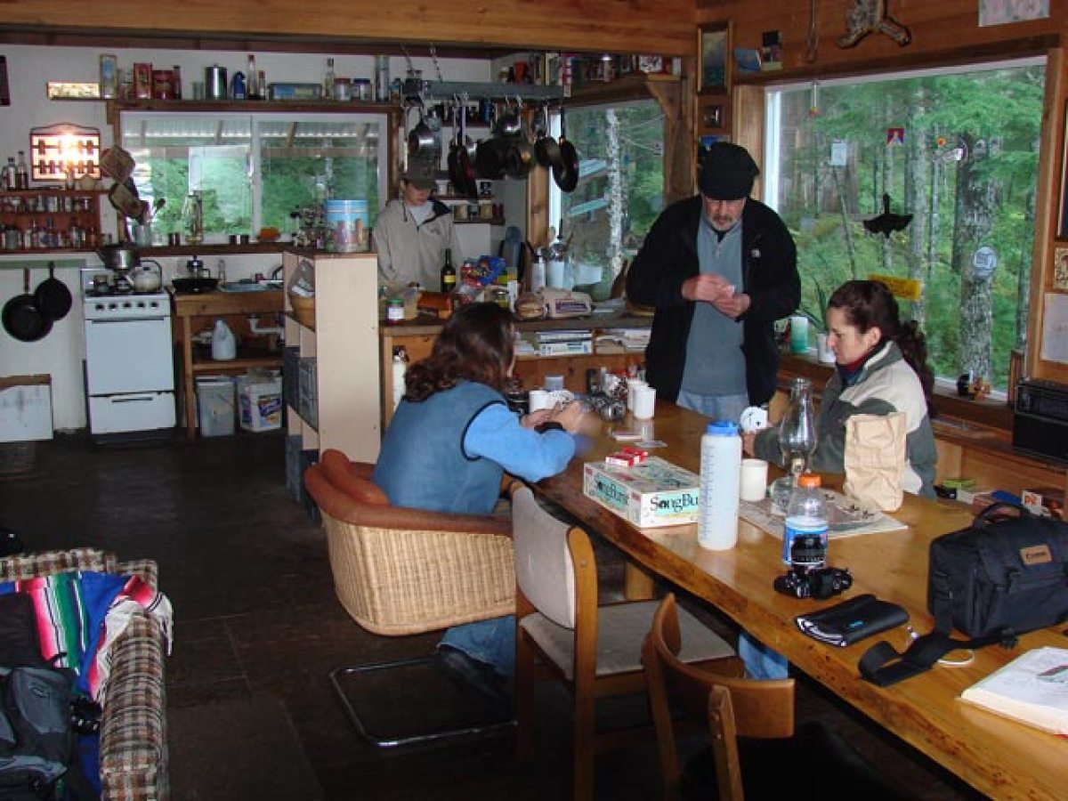 Kayakers Camping Hostel and Camping Cabin with people gathered around a table