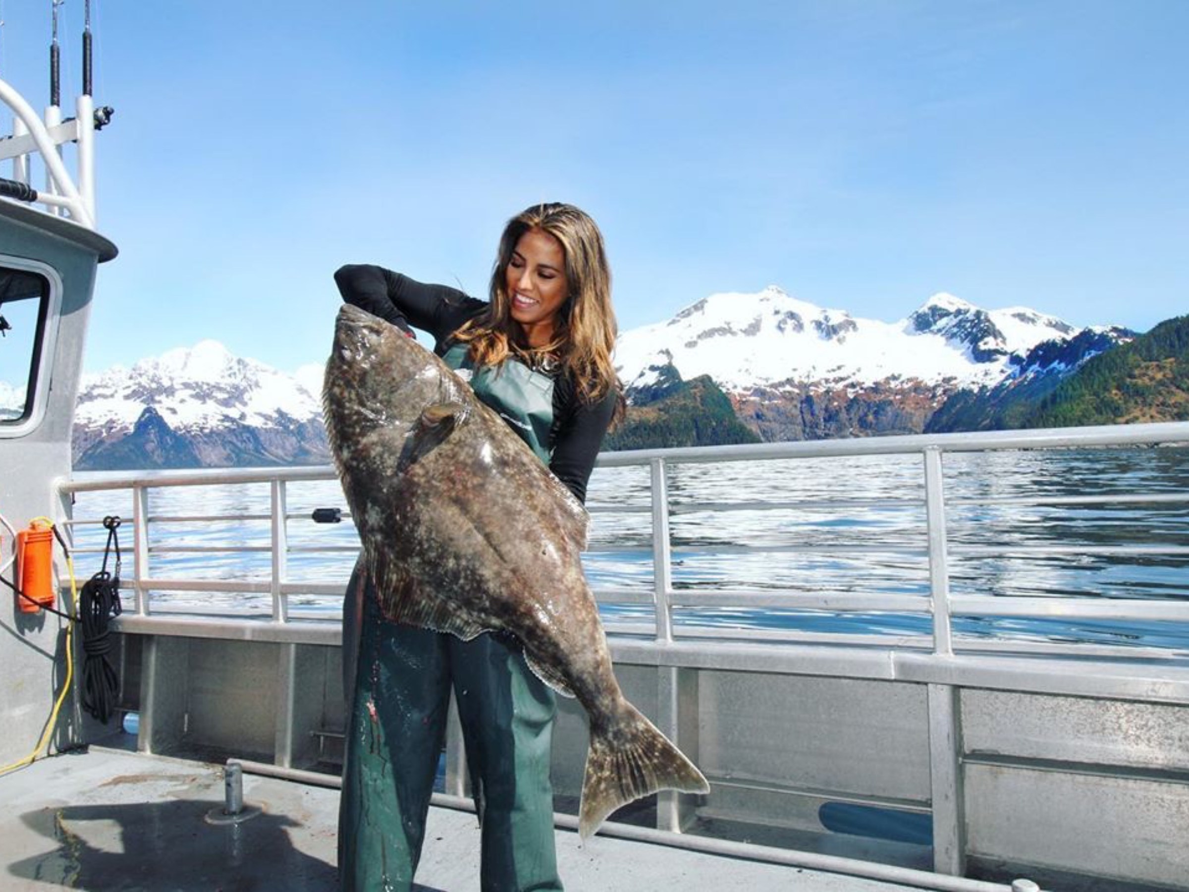 a statue of a man and a woman sitting at a dock