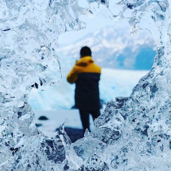 a man riding a snowboard down a snow covered slope