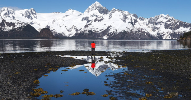 a lake with a mountain in the snow