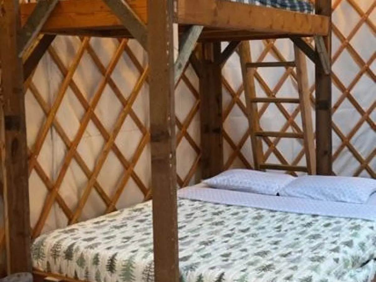 a bedroom with a bed and a chair in a room