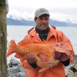 a person standing next to a body of water