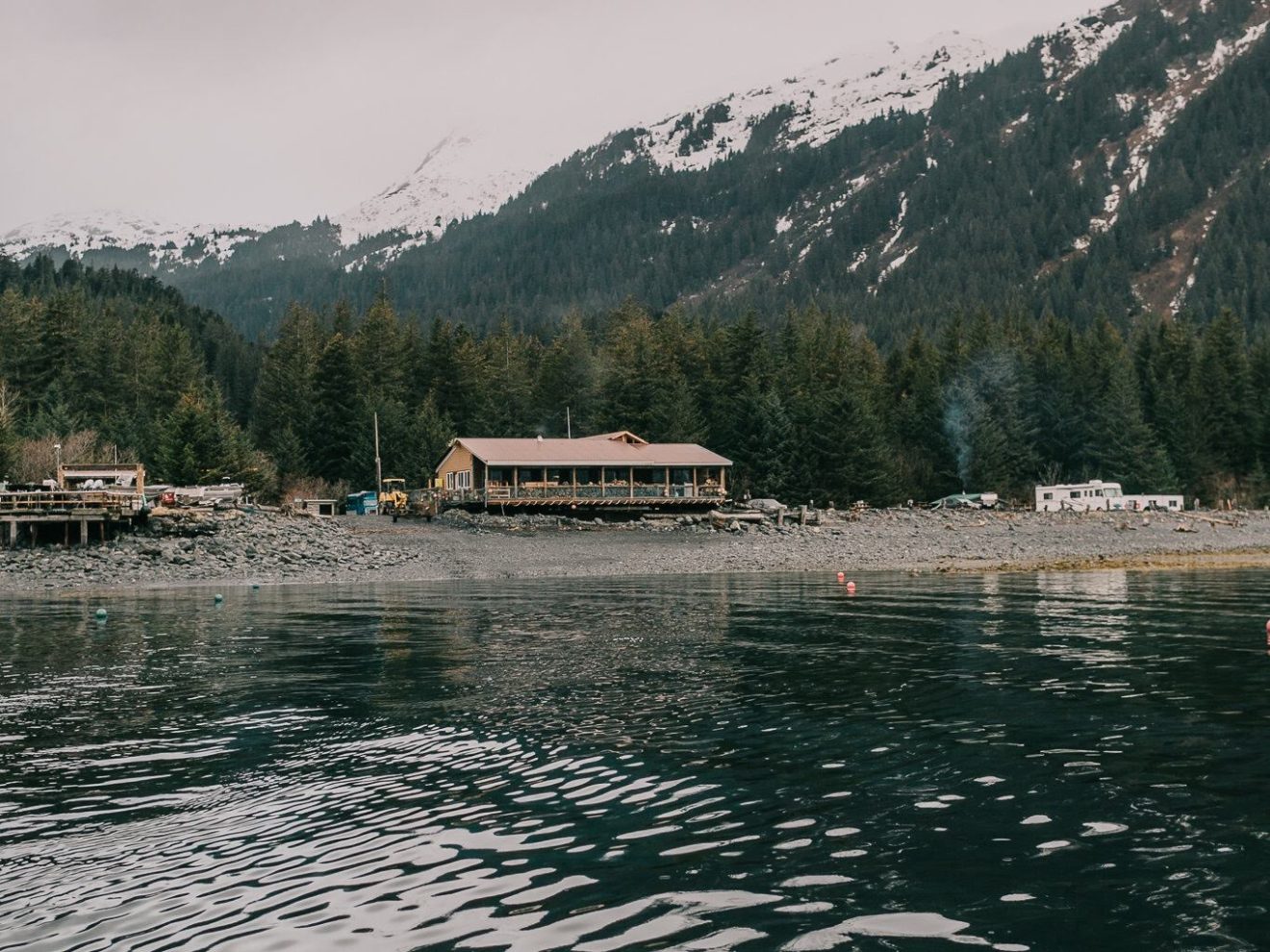 a body of water with a mountain in the background