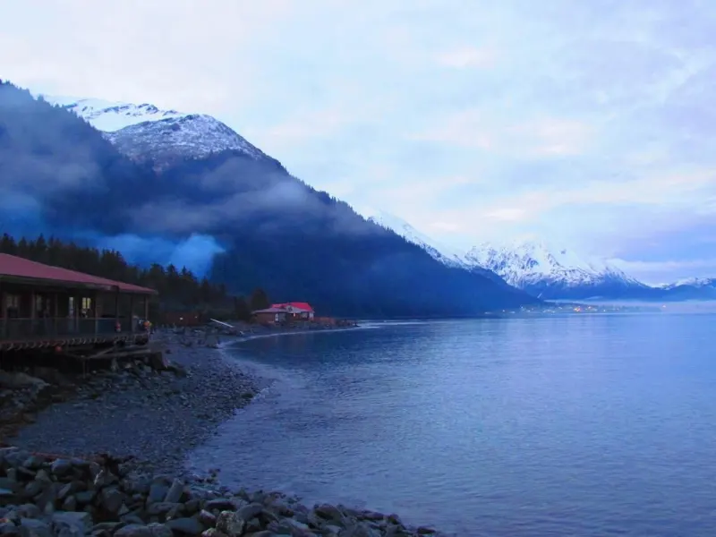 a body of water with a mountain in the background