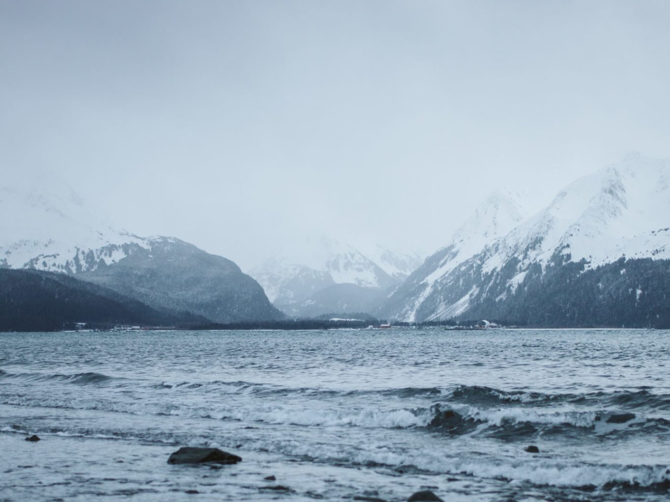 a body of water with a mountain in the background