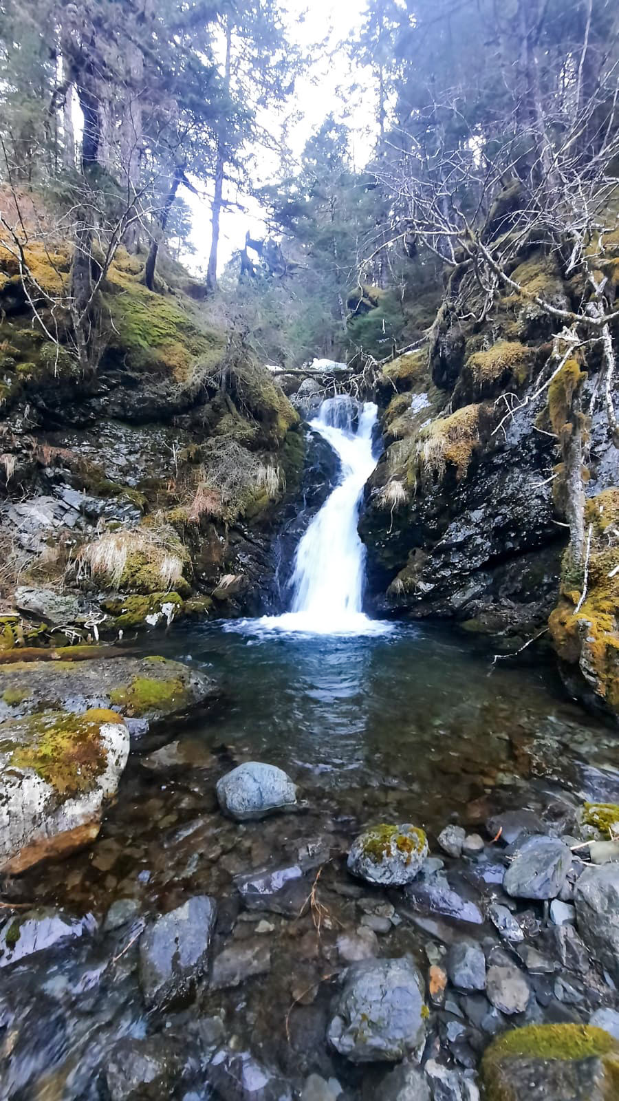 a large waterfall over a rocky cliff
