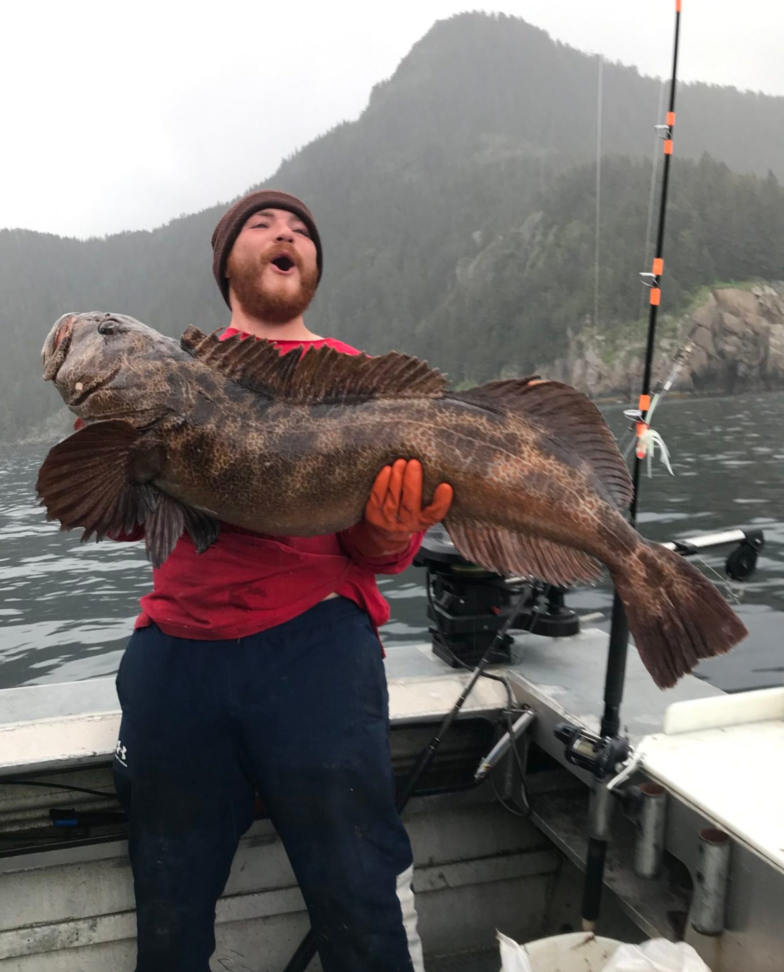 a man holding a fish in the water