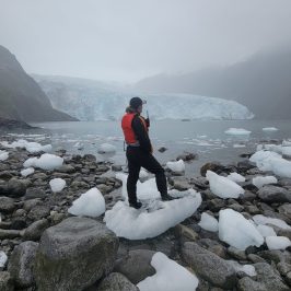 a man standing on top of a snow covered mountain