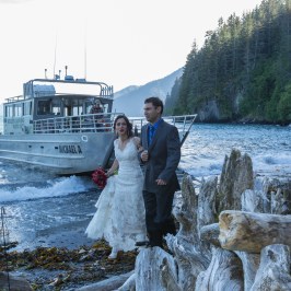 a man and a woman standing next to a river