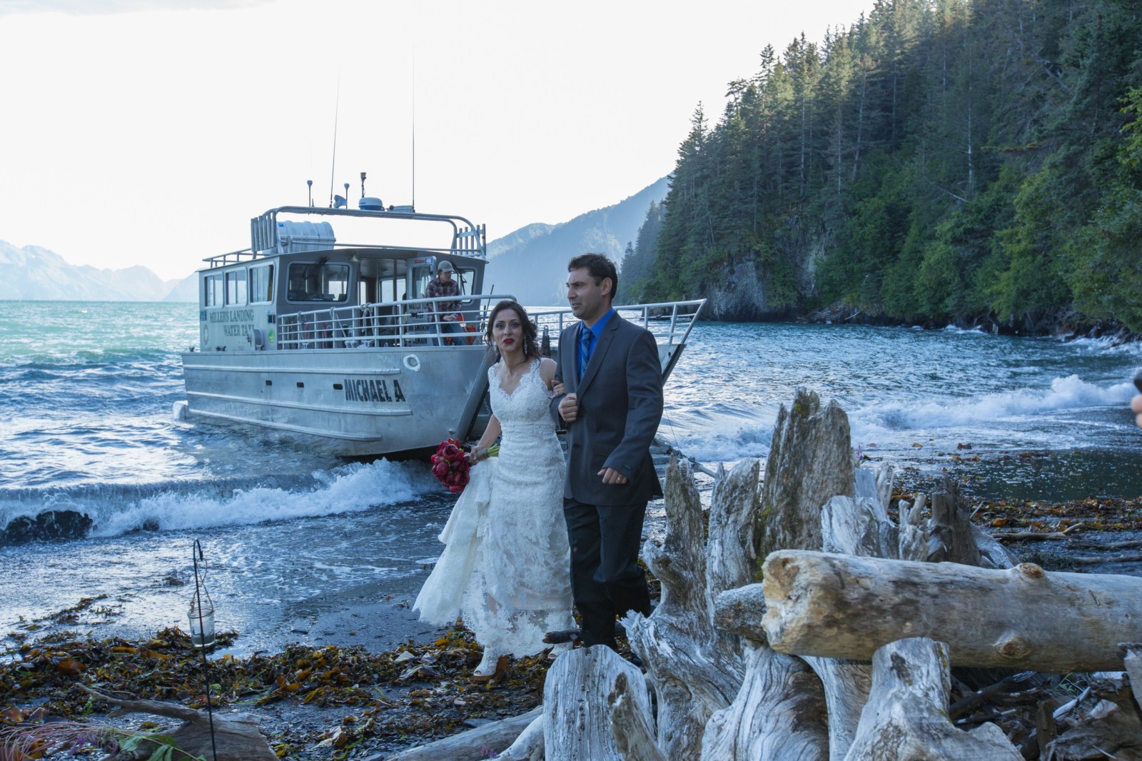 a man and a woman standing next to a river