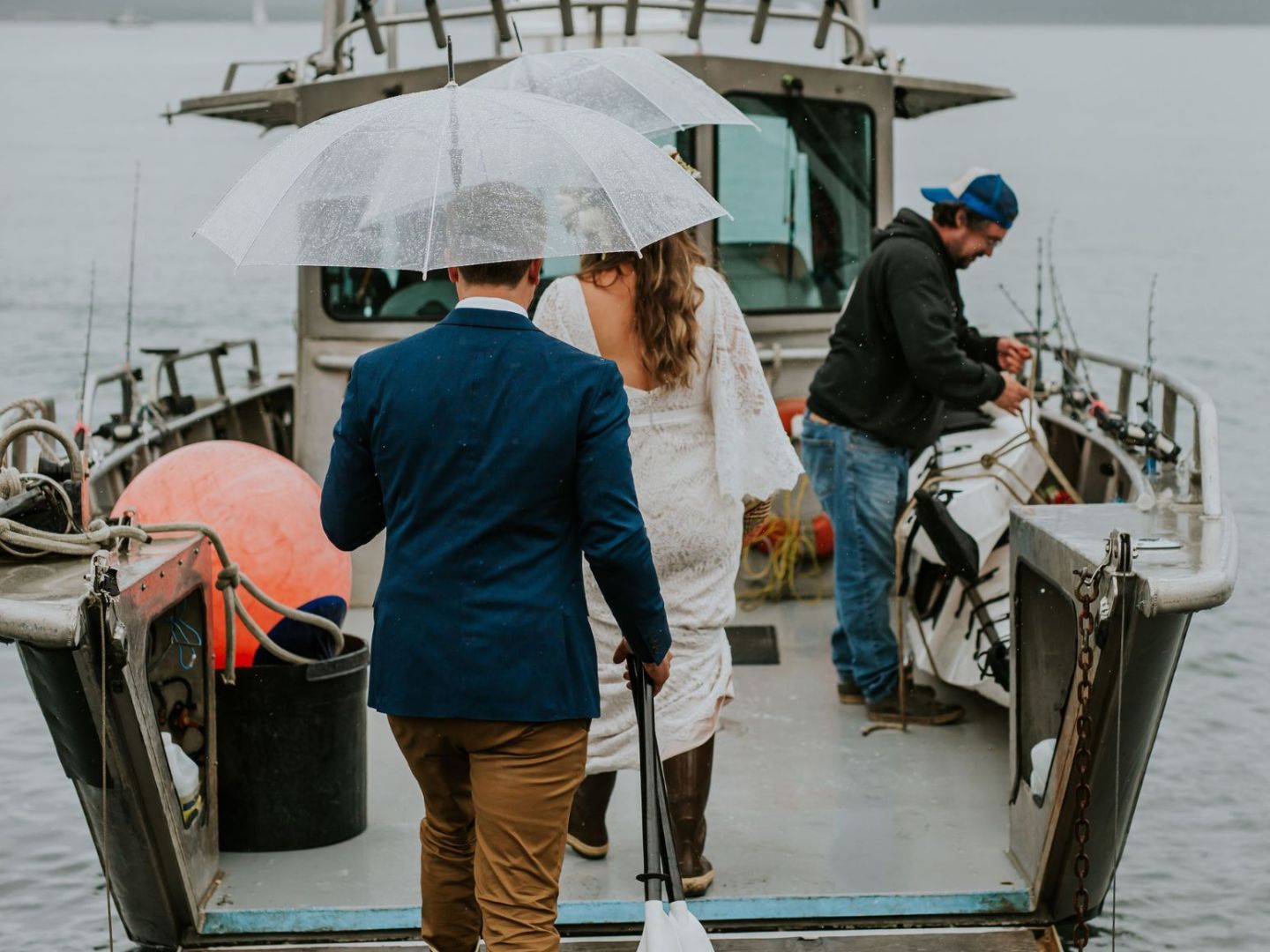 a man standing on a dock next to a body of water