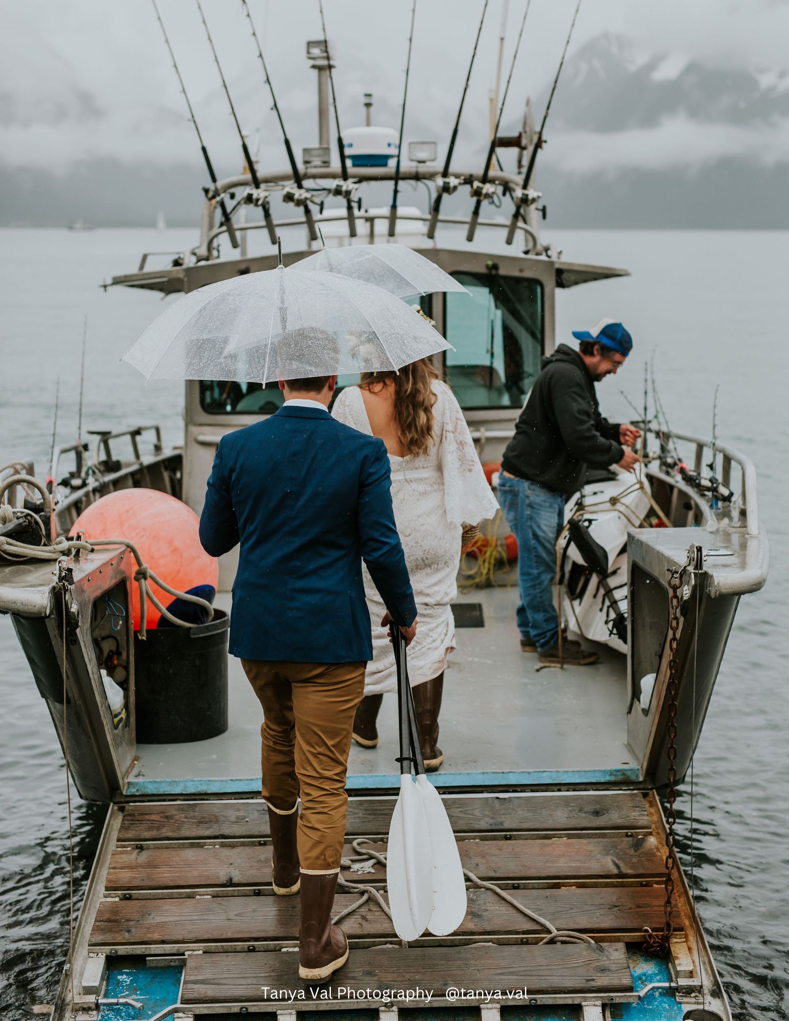 a man standing on a dock next to a body of water