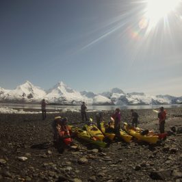 a group of people standing on top of a mountain