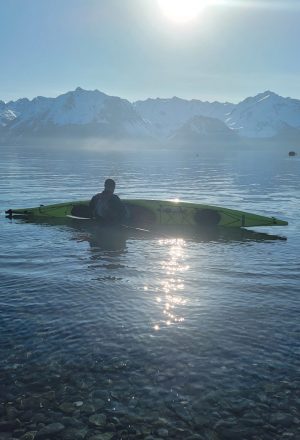 a man standing next to a body of water