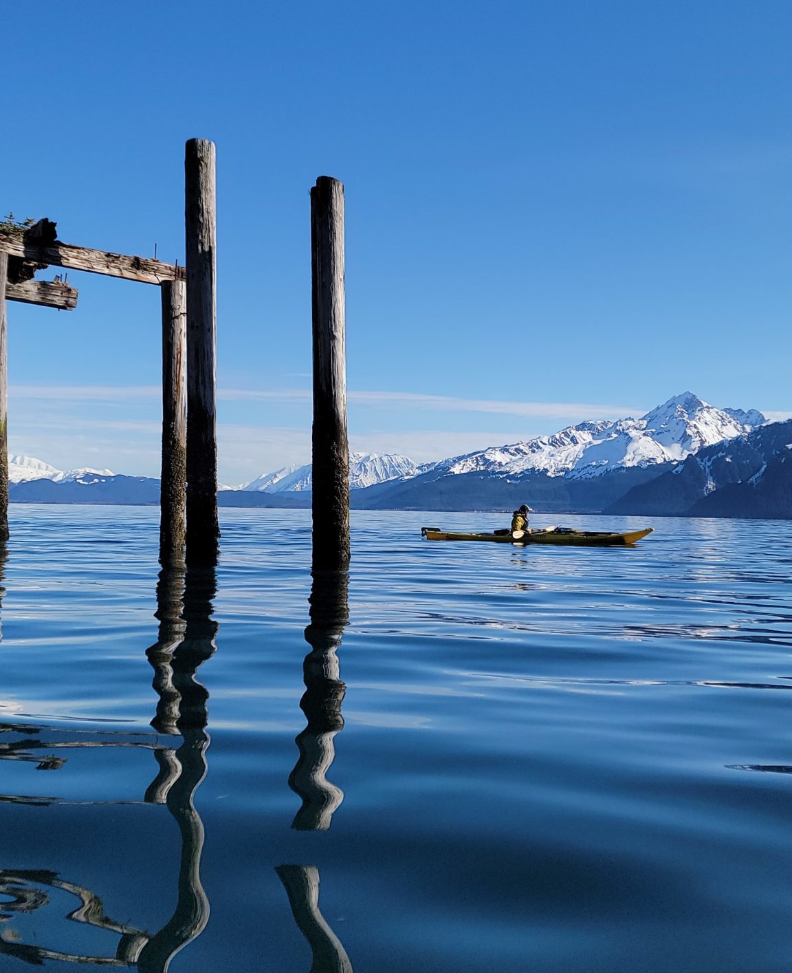 a close up of a pier next to a body of water