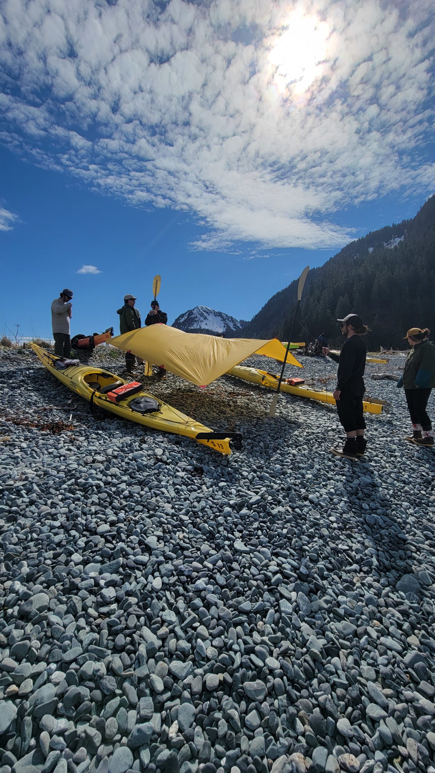 a group of people standing in a rocky area