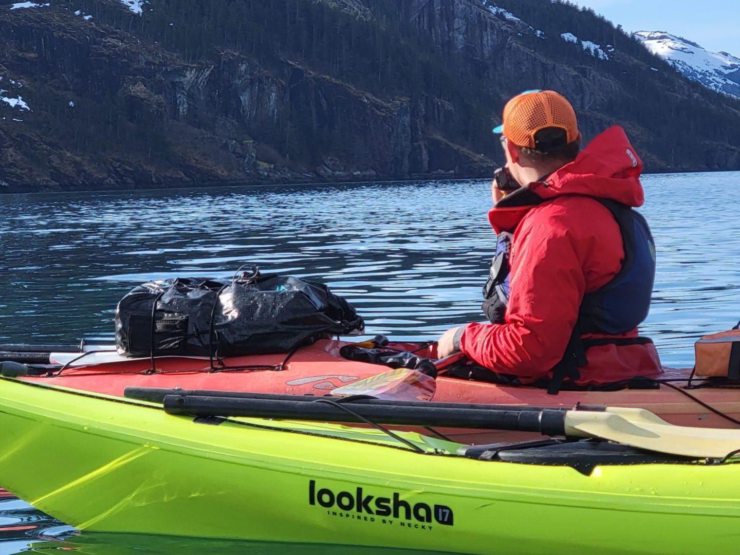 a man sitting in a boat on a body of water