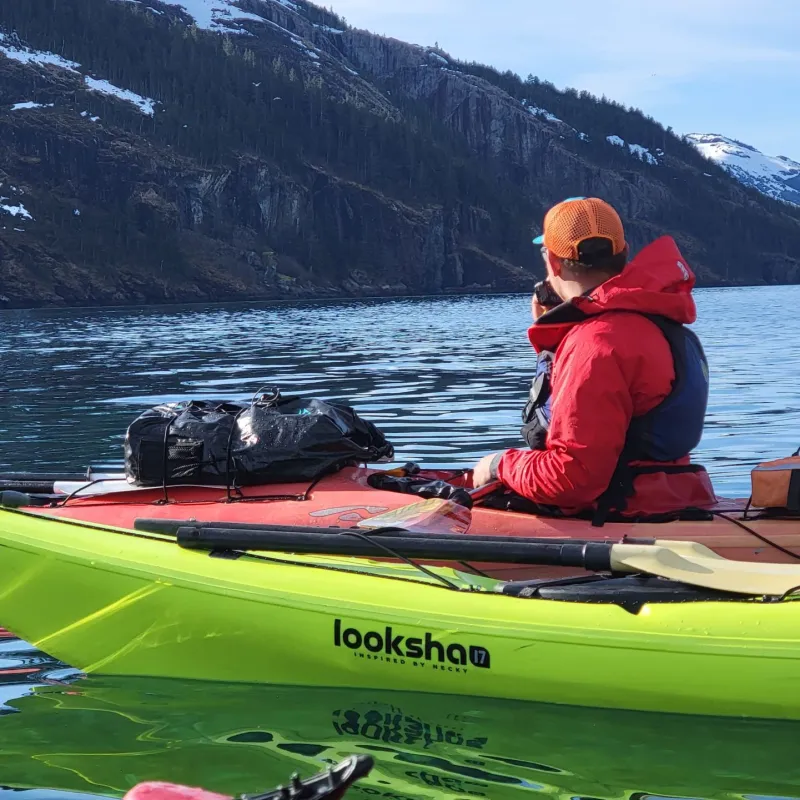a man sitting in a boat on a body of water