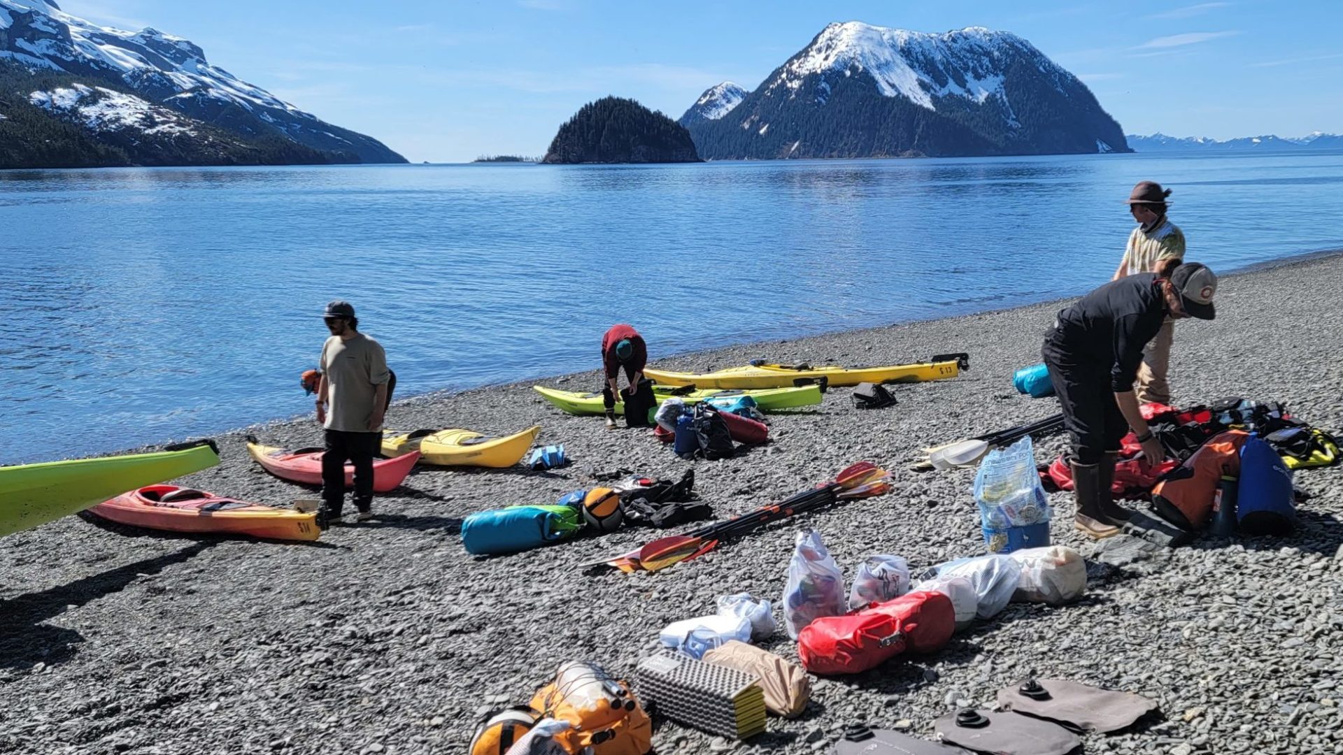 a group of people sitting at a beach