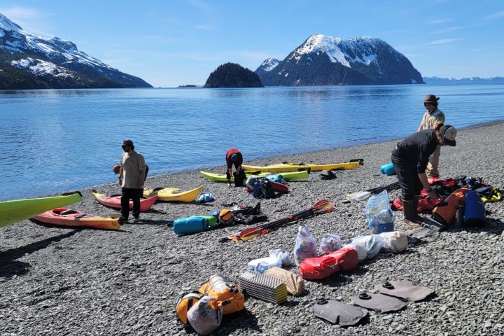 a group of people sitting at a beach