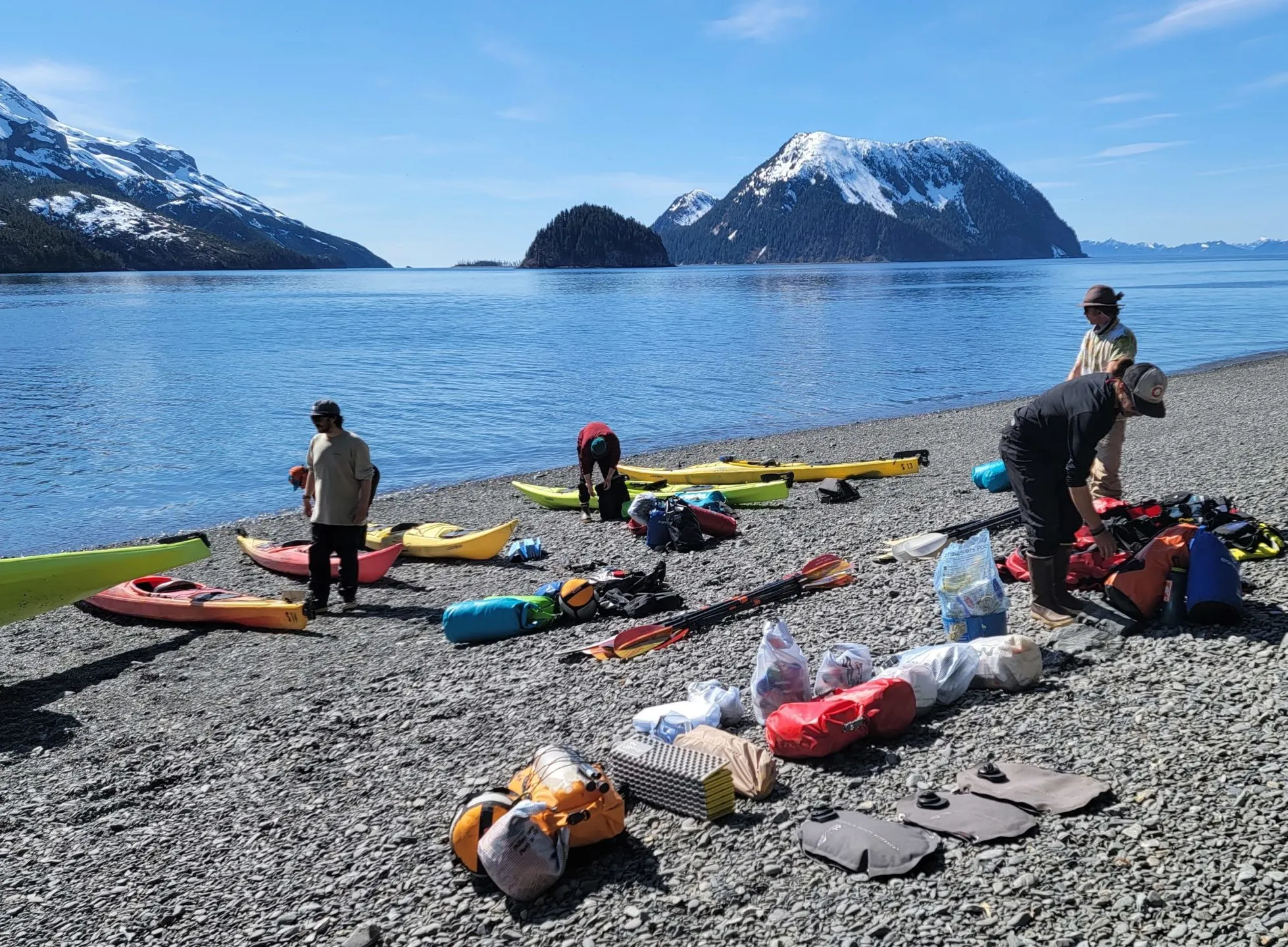 a group of people sitting at a beach