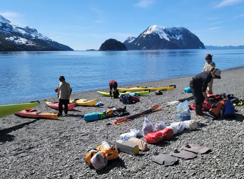 a group of people sitting at a beach