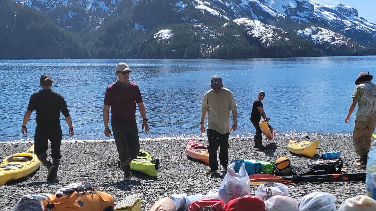 a group of people on a rocky beach