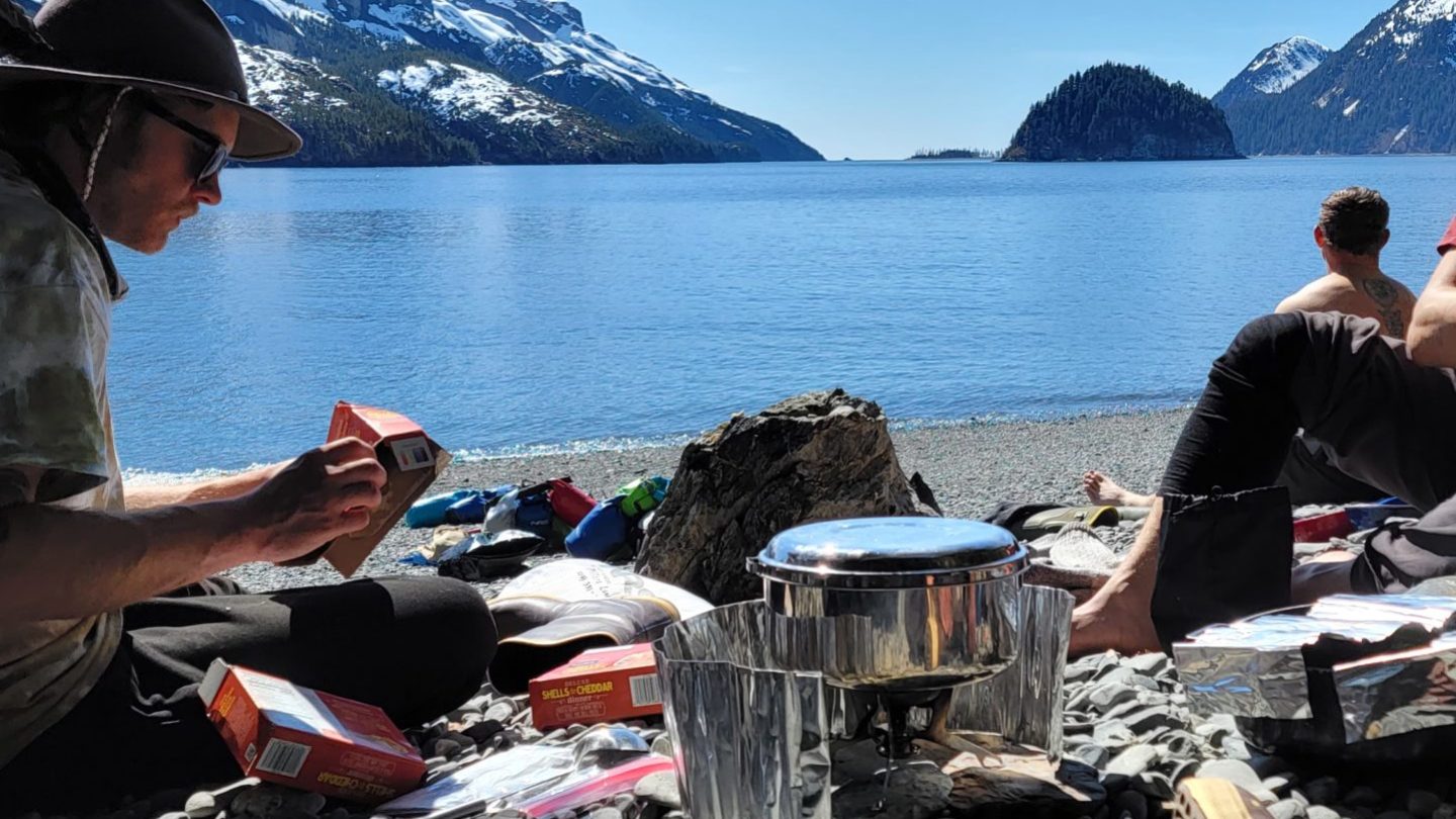 a person sitting on a rock near the ocean
