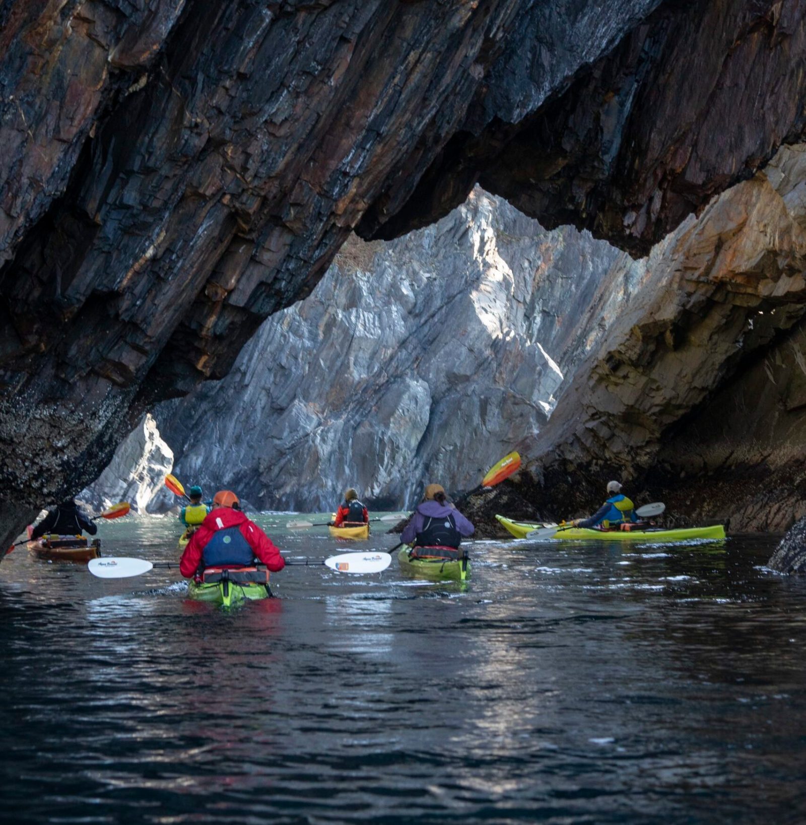 a group of people rowing a boat in the water