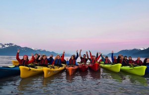 a group of people in a boat on a body of water