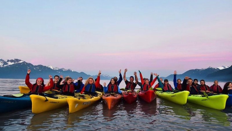 a group of people in a boat on a body of water