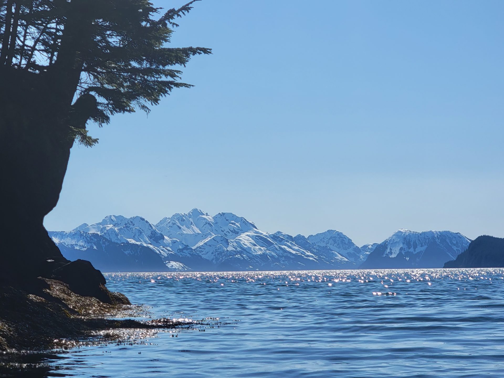 a large body of water with a mountain in the background