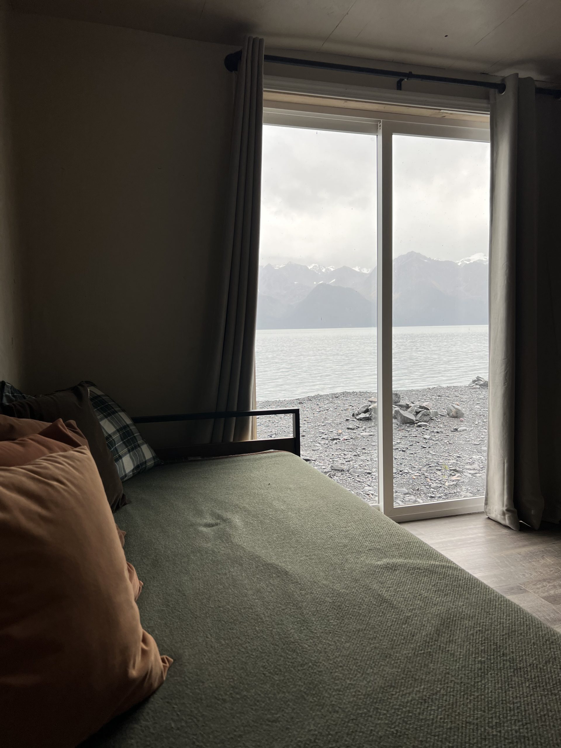 a view of a bedroom next to a body of water