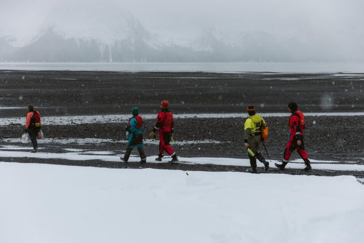a group of people riding skis on top of a snow covered slope