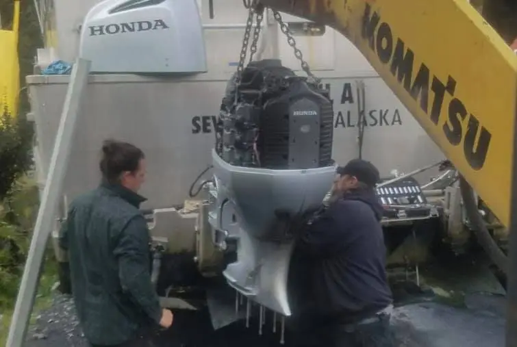 a group of people standing around a plane